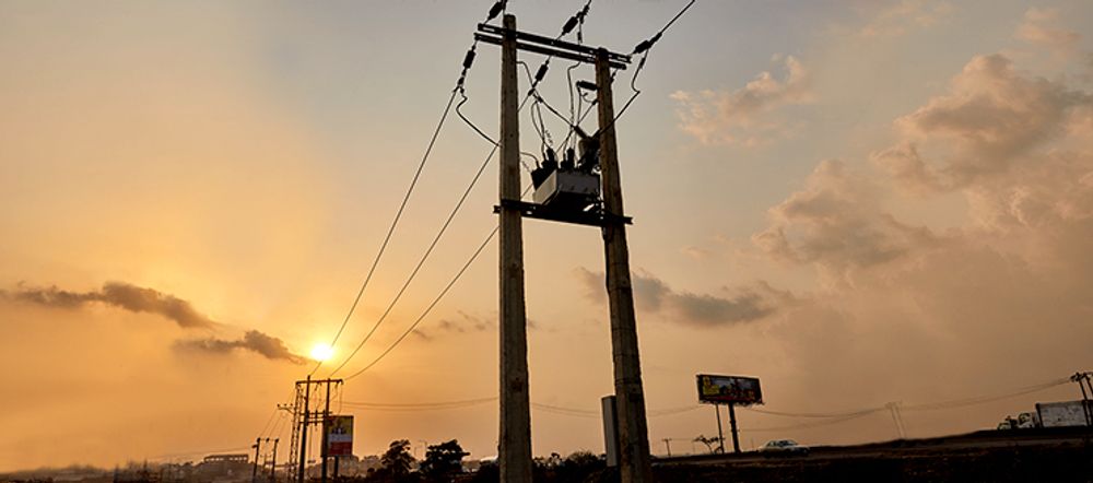 Ikeja Electric installation of NOJA Power’s OSM38 Recloser taken from the ground with the sunset in the background 