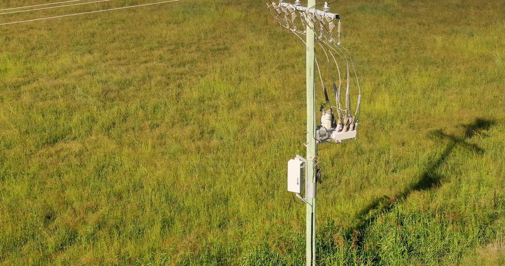 Pole mounted NOJA Power Installation in Regional Australia with green grass below 