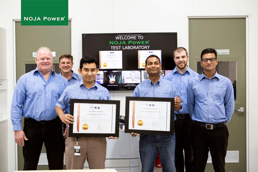 NOJA Power Test Laboratory team holding the certificates 