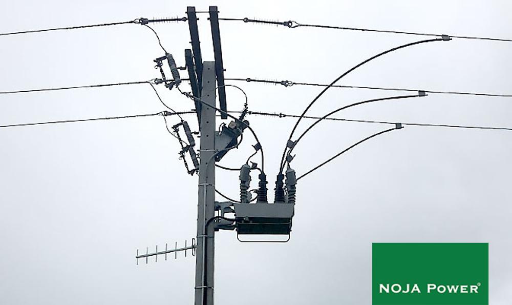 NOJA Power OSM Recloser on a powerline pole with grey skies behind, in a high risk earthquake area
