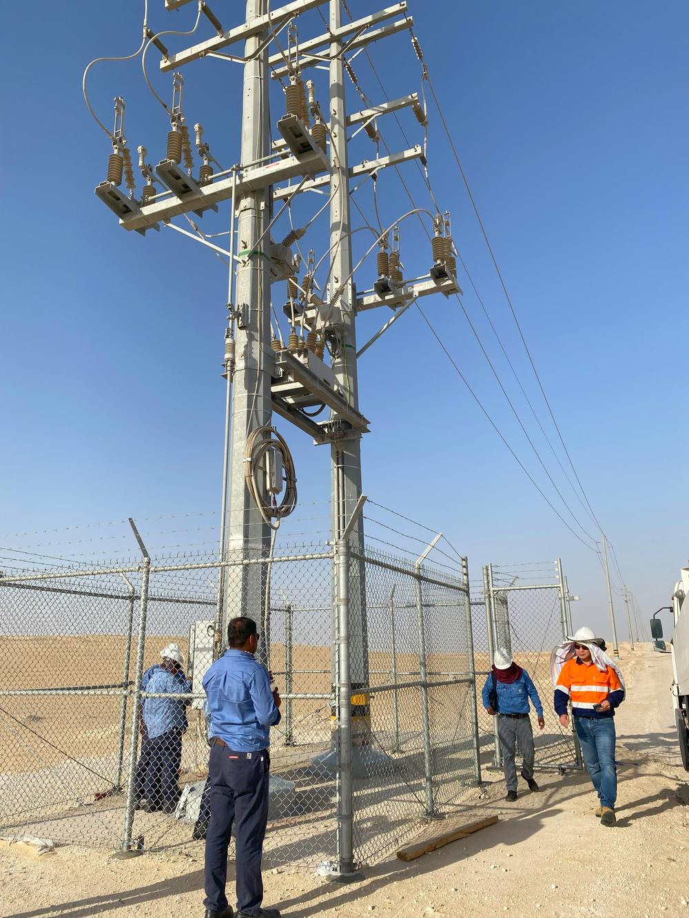 Engineers inspect a NOJA Power OSM Recloser installation in the Saudi Aramco Jafurah project in Saudi Arabia