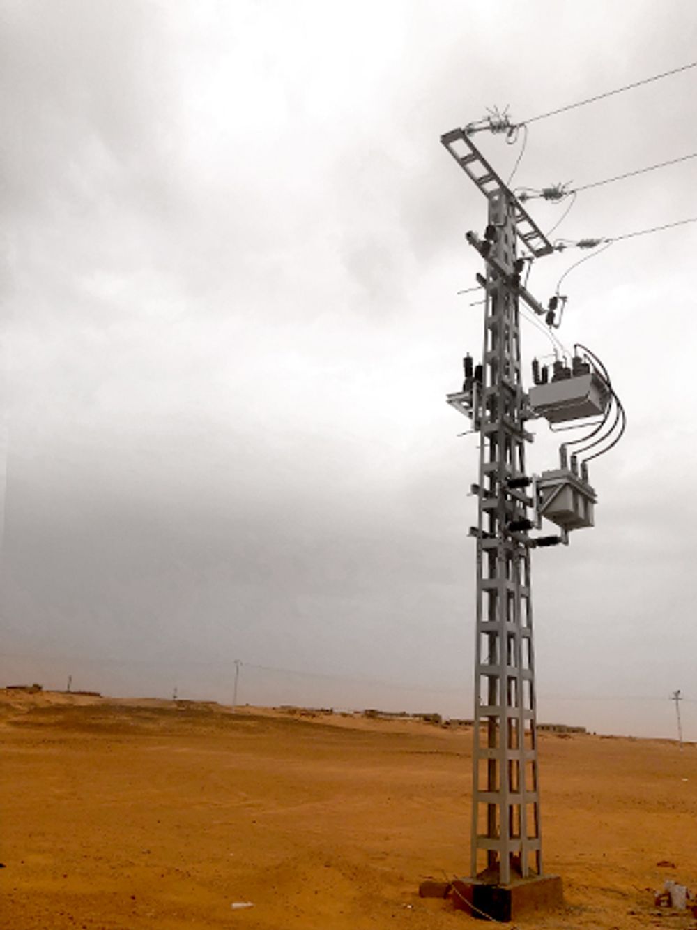 Pole Mounted Capacitor bank switching with grey skies and red dirt background