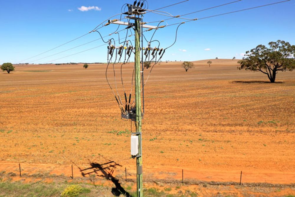 NOJA Power OSM Recloser installation in outback Australia with red dirt and clear blue skies in the background