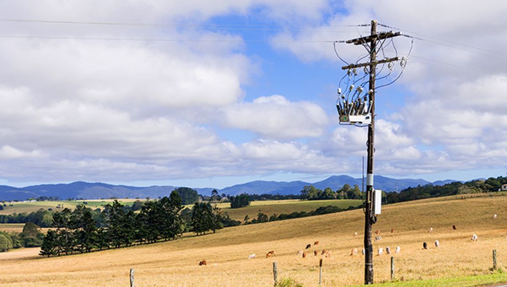 Pole-mounted NOJA Power Installation in NSW with hills and cloudy sky background