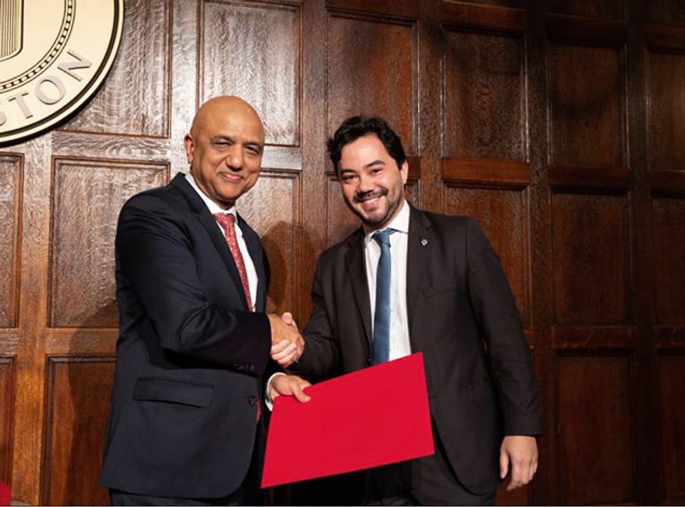 NOJA Power Brazil CEO and MD Bruno Kimura receiving his certification and shaking hands with Harvard representative