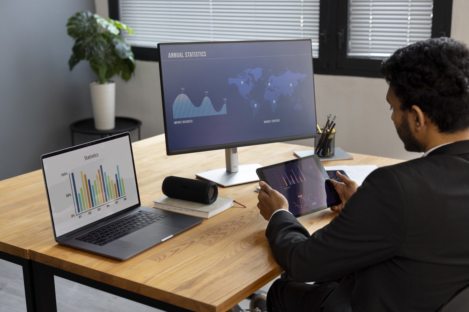 Engineering leader comparing productivity charts on a laptop and a large monitor