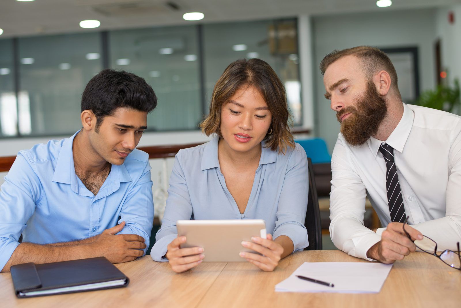Engineering and finance leads reviewing AI tool spend together at a meeting table