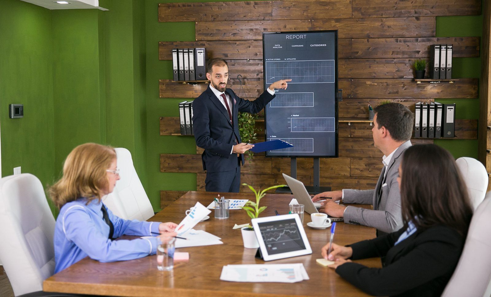 Engineering leader presenting quality risk charts to executives in a conference room