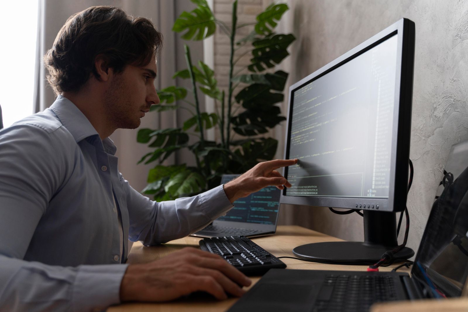 Developer writing test automation code on a laptop, close up on the screen