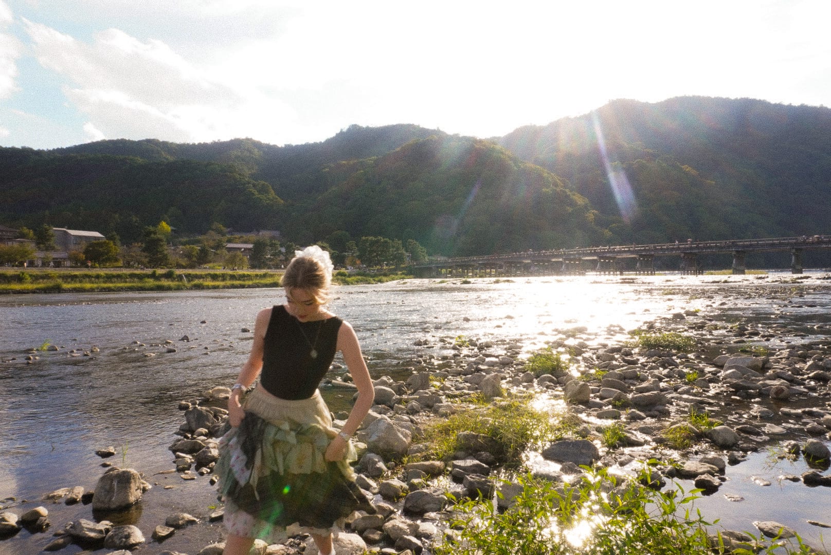 Woman crossing river in kyoto
