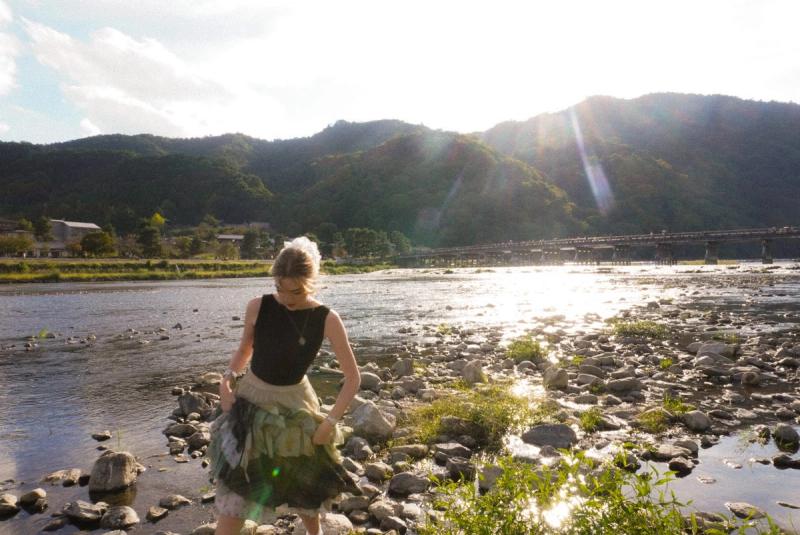 Woman crossing river in kyoto