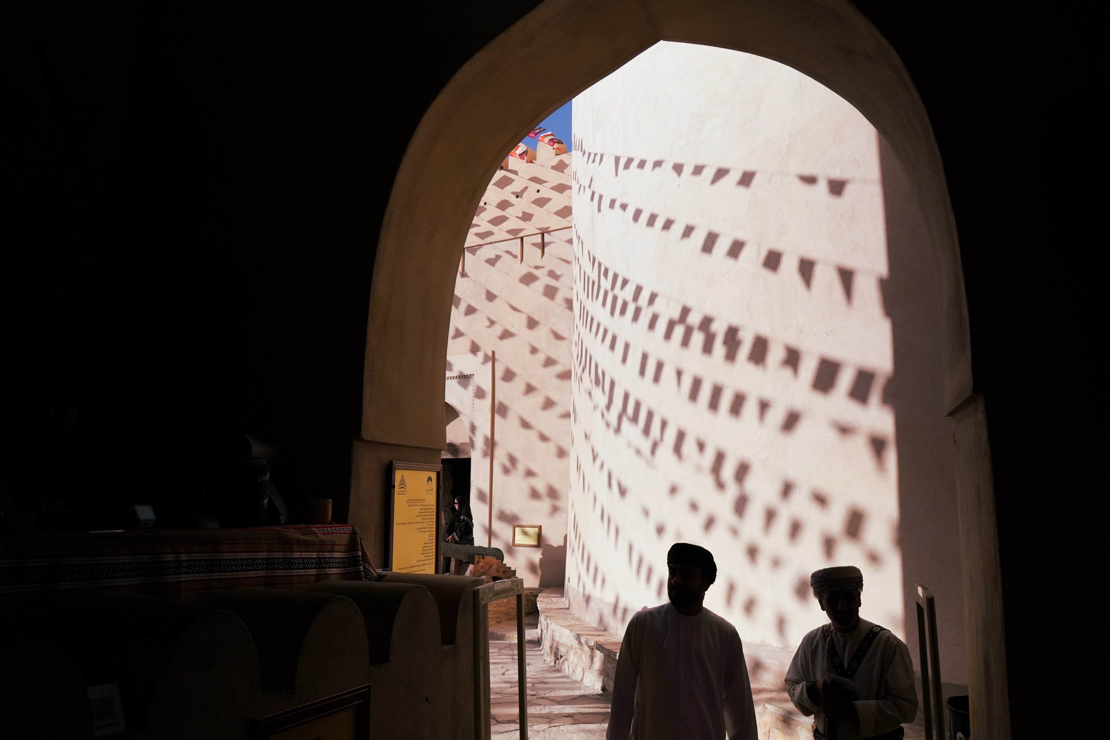 The silhouettes of two men stood at an entrance.