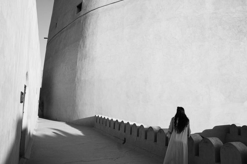 The curved outer wall of the fort, abrupted by the linear angles of a walkway