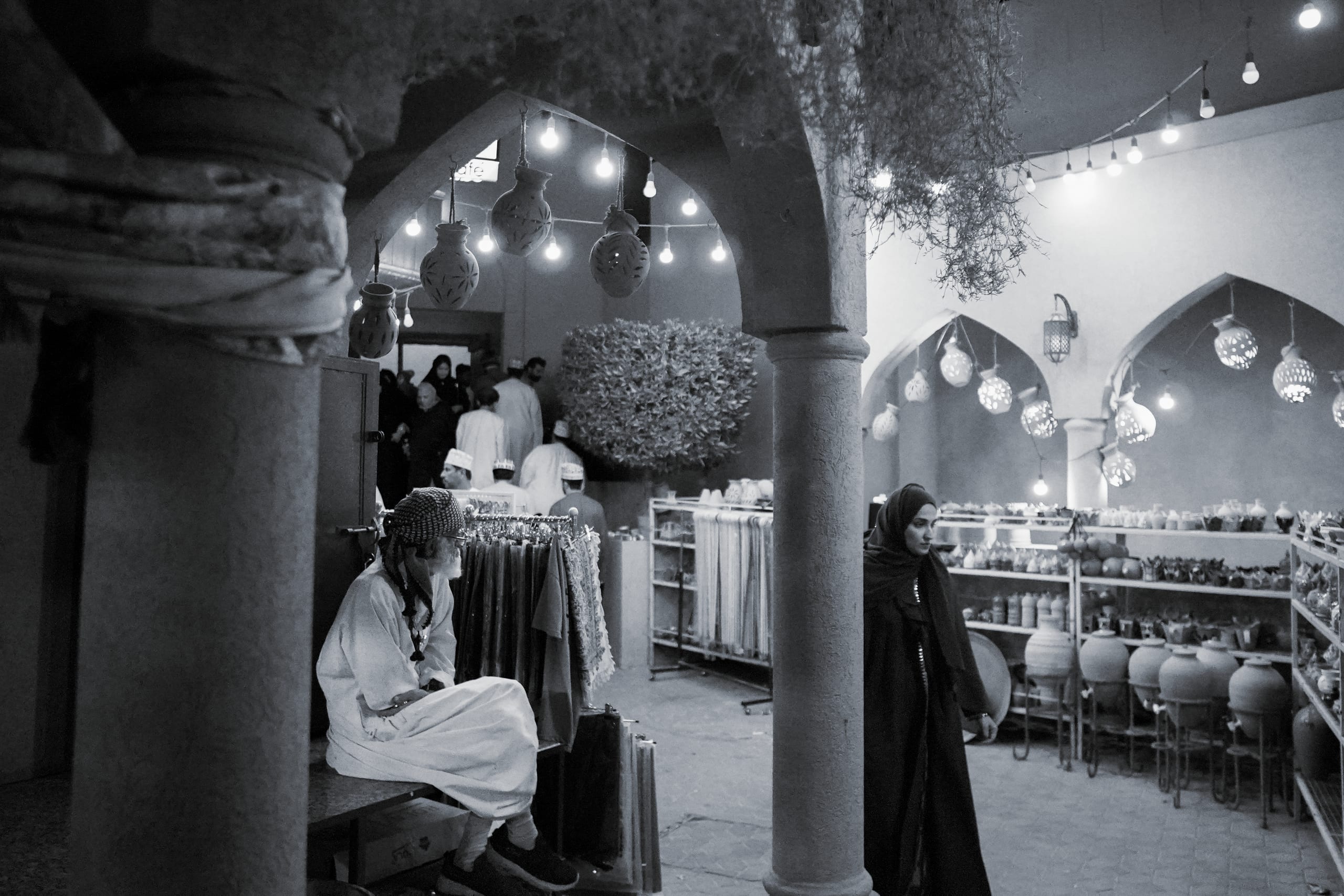 A man watching a woman pass by in a Souk