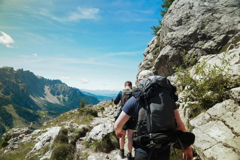 Two hikers on a cliffside