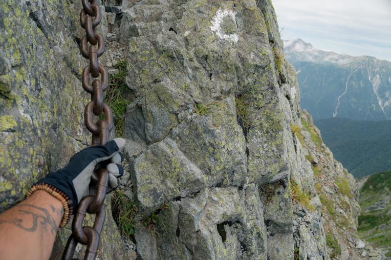 Clinging onto chains, making your way up the ridge