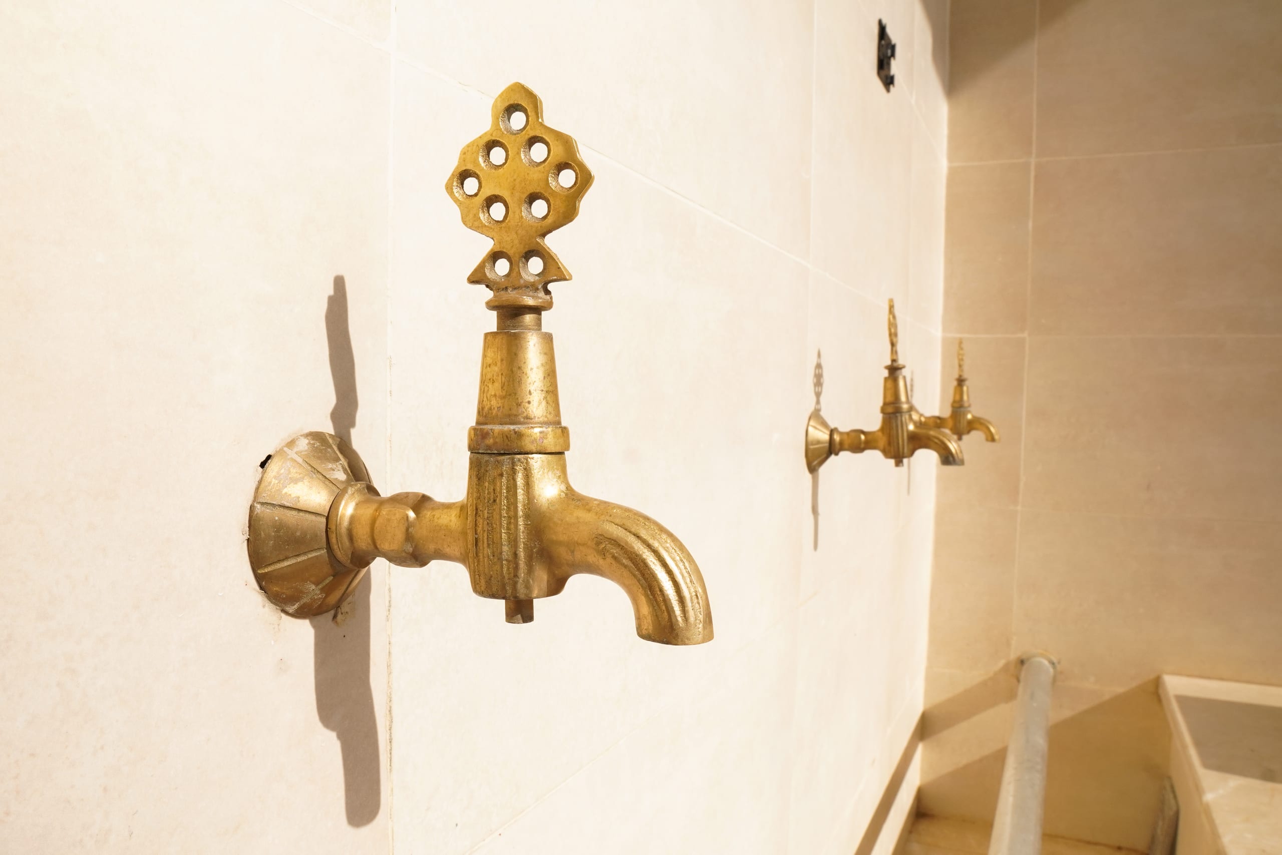 Golden taps outside a mosque, where murids make wudu