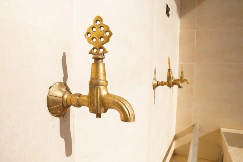 Golden taps outside a mosque, where murids make wudu