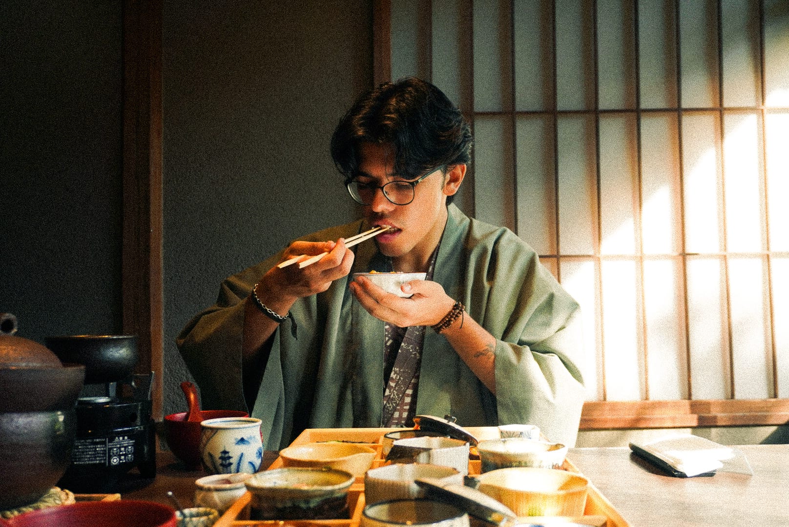 A man eating rice in traditional clothing.