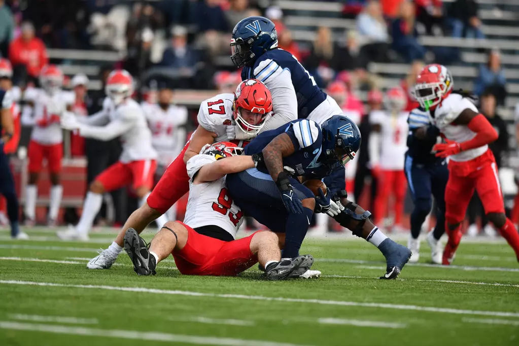 Youngstown State defenders tackle a member of the Villanova Offense