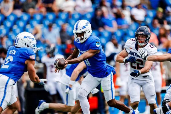 Air Force Academy QB Josh Johnson hands the ball off to RB Owen Allen