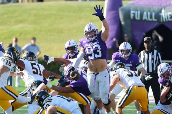 Furman DE Jack Barton attempts to block a kick by ETSU