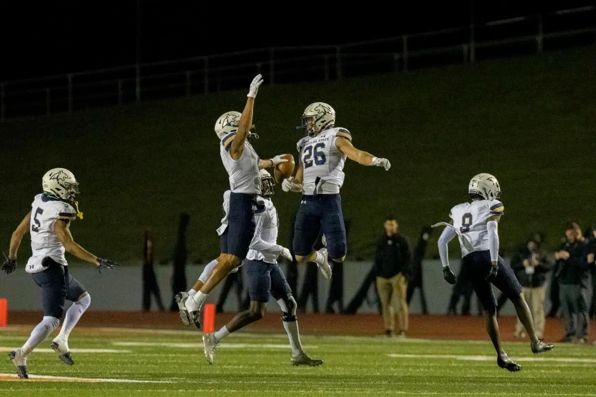 Montana State's Tre Webb and Rylan Ortt (26) jump in celebration after Webb's interception during Saturday's FCS quarterfinal game against Sam Houston at Bowers Stadium in Huntsville, Texas.