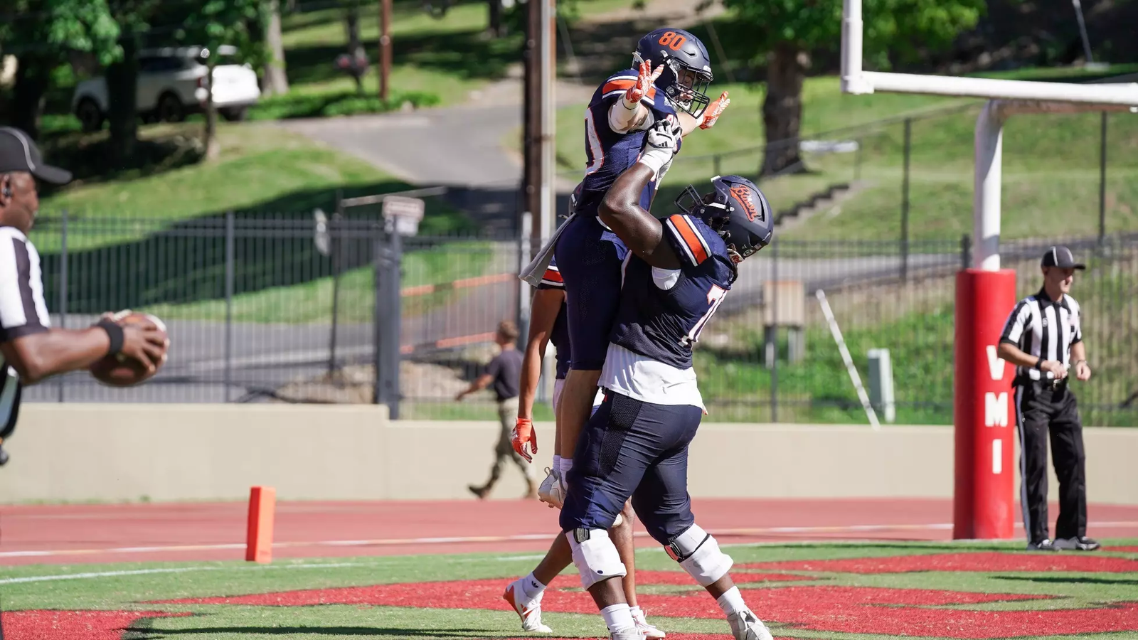 Bucknell football players celebrate in the end zone after scoring a touchdown against VMI.