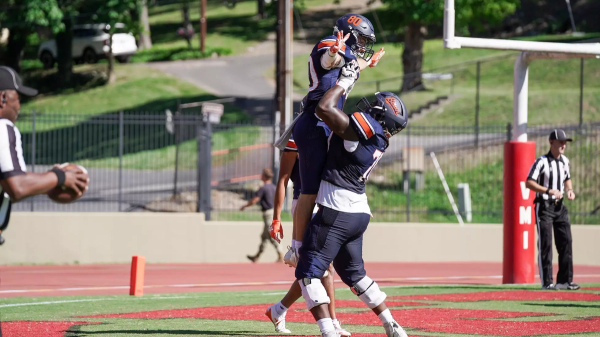 Bucknell football players celebrate in the end zone after scoring a touchdown against VMI.