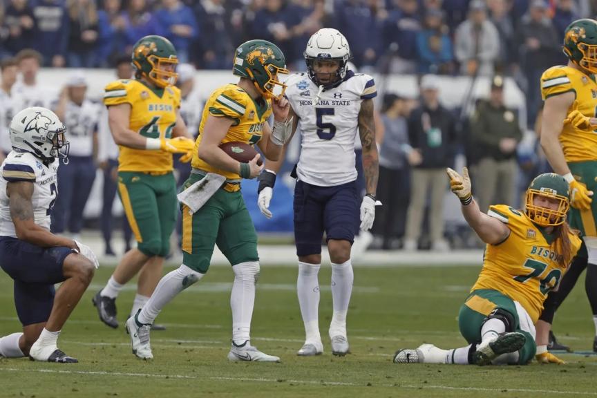 North Dakota State offensive lineman Cody Mauch, right, slides to signal a first down during the NCAA FCS Championship game.