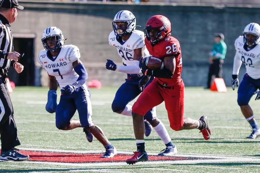 Harvard’s DeMarkus Stradford zooms past Howard’s Ray Williams (7) and Deionte Davis (36). The Crimson sophomore scored three times, on rushes of 33 and 59 yards and on an end-zone recovery of a punt he blocked.