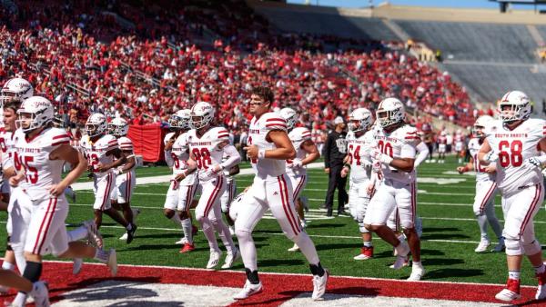 USD team running off the field at Wisconsin in 2024 game
