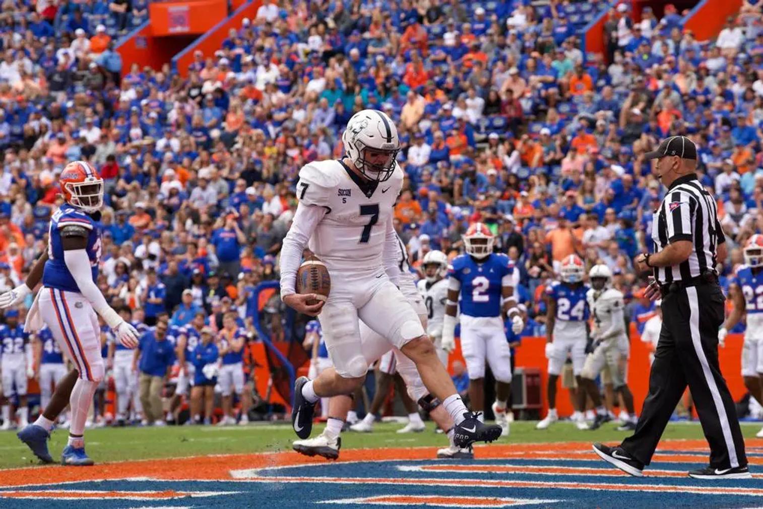 Samford QB Welch scores a rushing touchdown at Florida. Nov. 13, 2021.