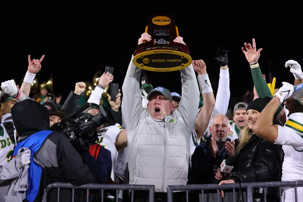 North Dakota State Tim Polasek raises the FCS Championship trophy