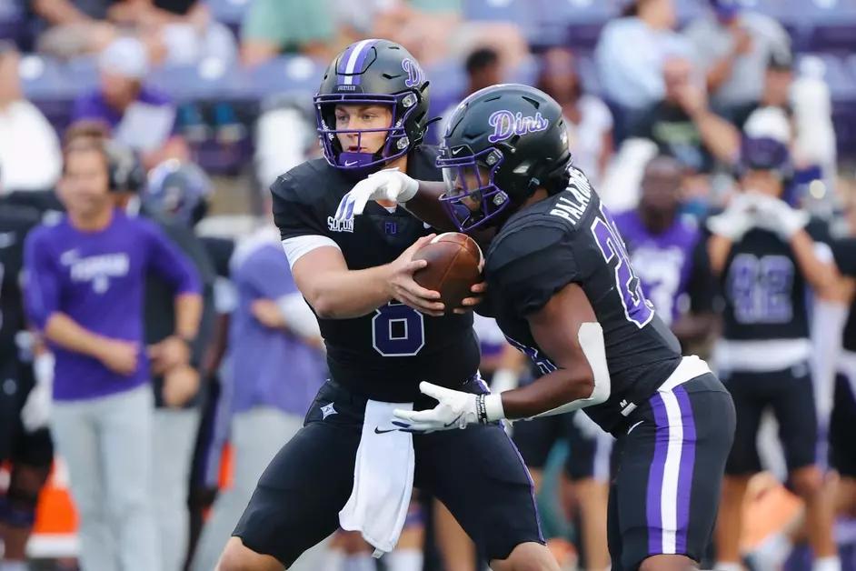 Furman Freshman QB Trey Hedden has the ball off to RB Grant Robinson
