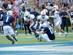 Chattanooga RB Ailym Ford runs over Samford defender during their 47-24 victory