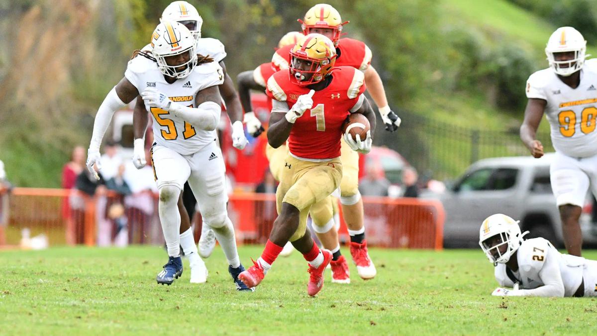 VMI's running back Korey Bridy rushes against UTC's defense.