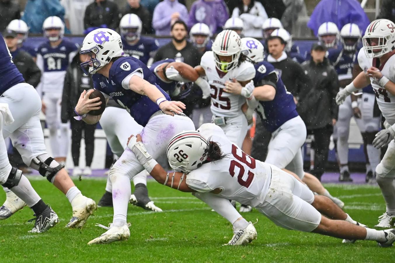 Lafayette's #26 attempts a tackle against Holy Cross' QB