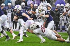 Lafayette's #26 attempts a tackle against Holy Cross' QB