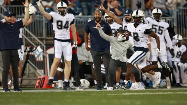 UConn WR TJ Sheffield running down the sideline after catching a pass during their win over Temple