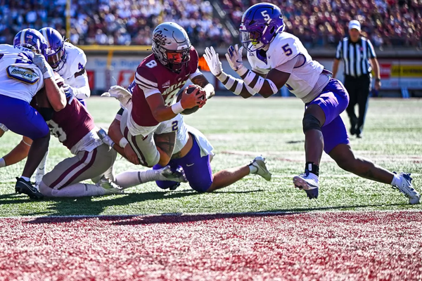 Montana QB Keali'i Ah Yat lays out for a touchdown against Western Carolina while WCU Linebacker Hayward McQueen Jr. attempts a tackle.