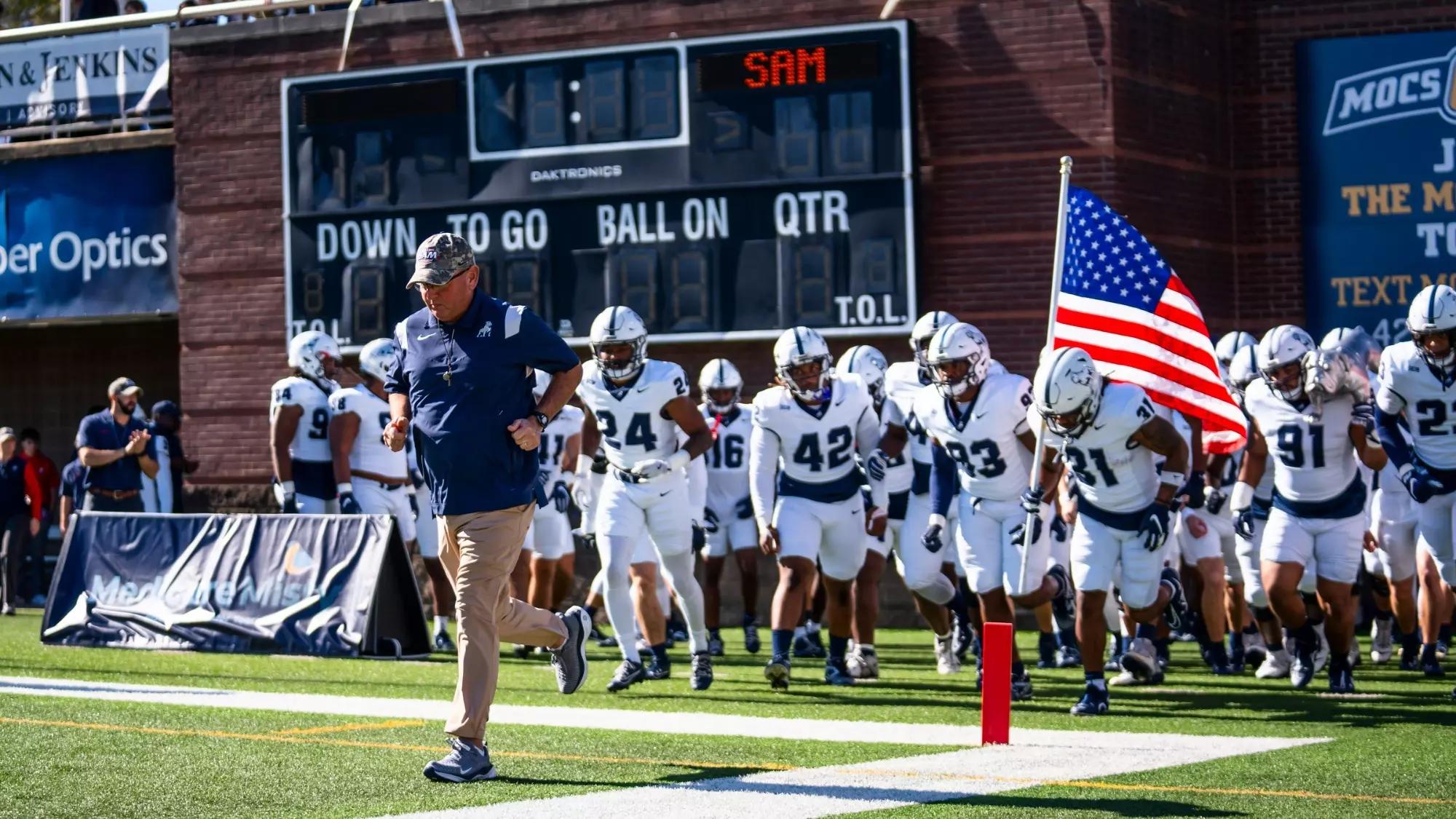 Former Samford HC Chris Hatcher leads the team out onto the field vs Chattanooga
