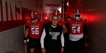 Youngstown State's Head Coach Doug Phillips leading the team from the locker rooms onto the field