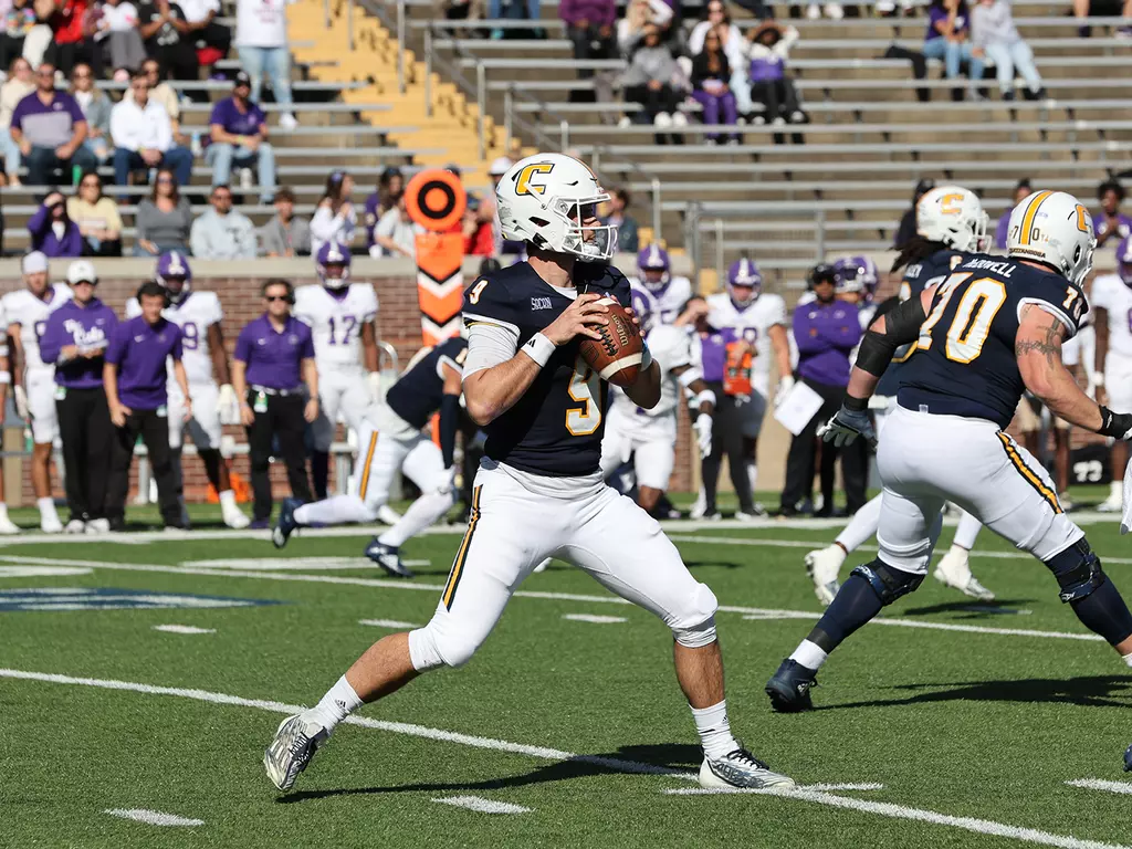 UT Chattanooga QB Chase Artopoeus steps back to attempt a pass against Western Carolina