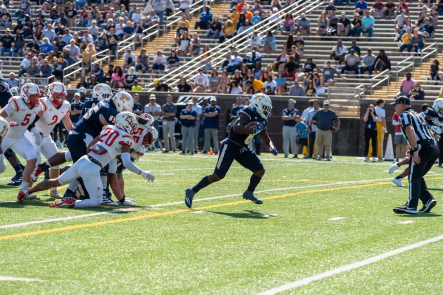 UTC's Appleberry runs away from VMI defenders during their 41-13 victory over VMI