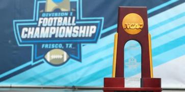 FCS Championship trophy in front of Division I Football Championship banner in Frisco, Tx