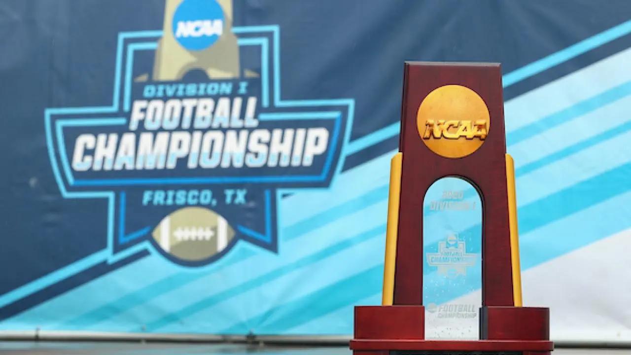 FCS Championship trophy in front of Division I Football Championship banner in Frisco, Tx