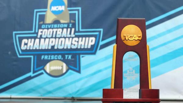 FCS Championship trophy in front of Division I Football Championship banner in Frisco, Tx
