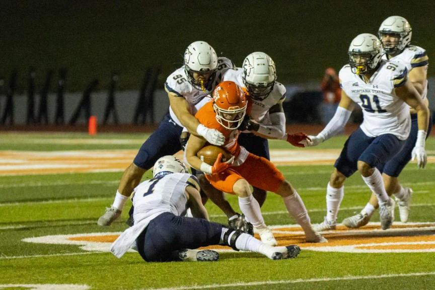 Sam Houston quarterback Eric Schmid is brought down by a group of Montana State defenders.