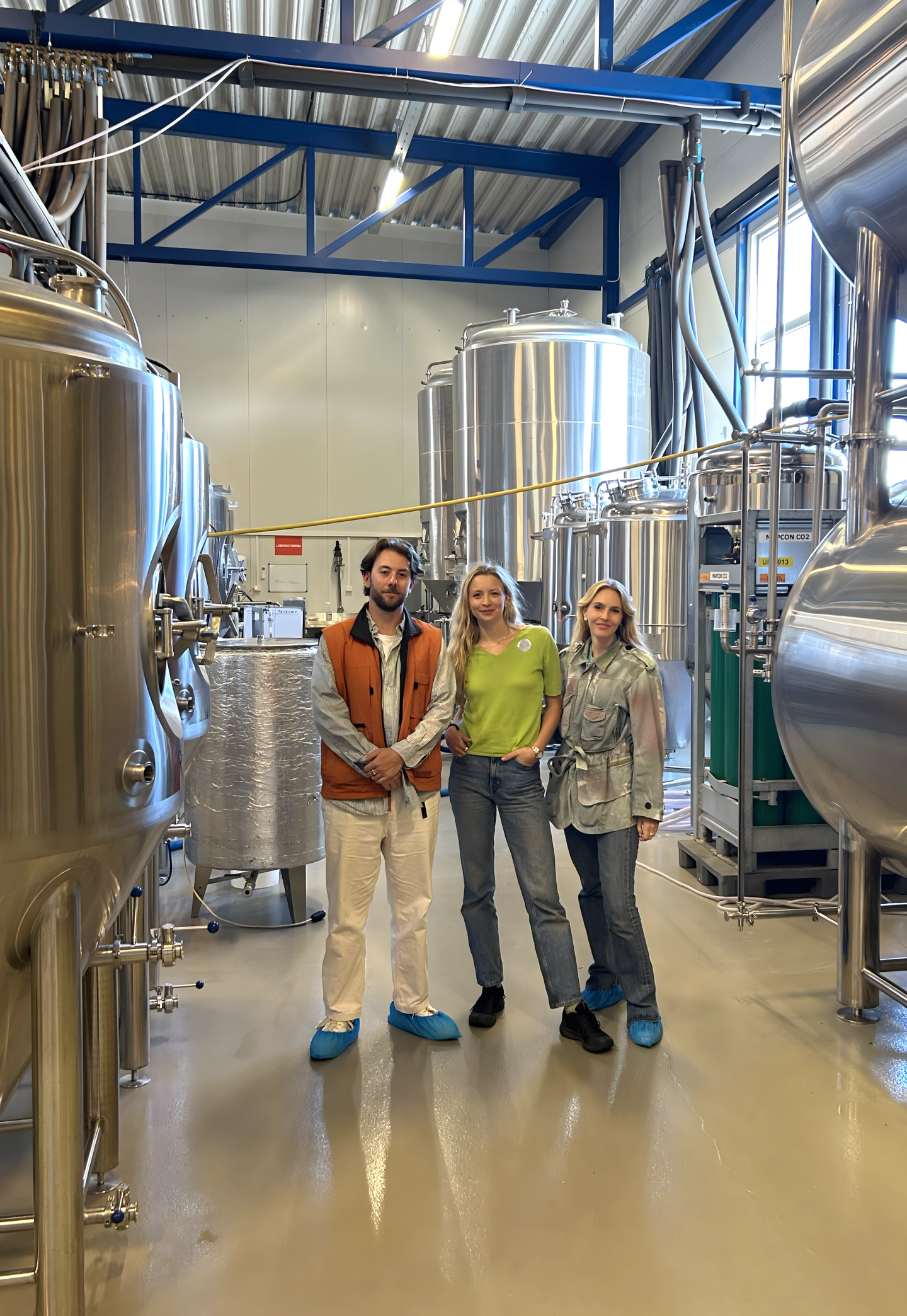 team villbrygg people in front of brewery equipment
